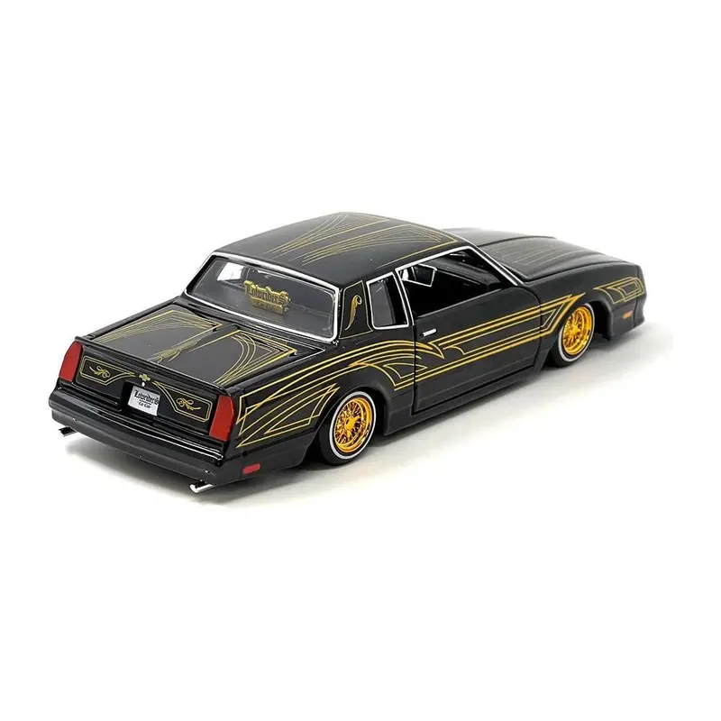 1986 Chevrolet Monte Carlo Ss Lowrider Black Metallic With Gold Graphics And Wheels "Lowriders" Series 1/24 Diecast Model Car By Maisto 1